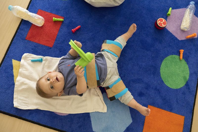 A teacher and parent with a child at the nursery